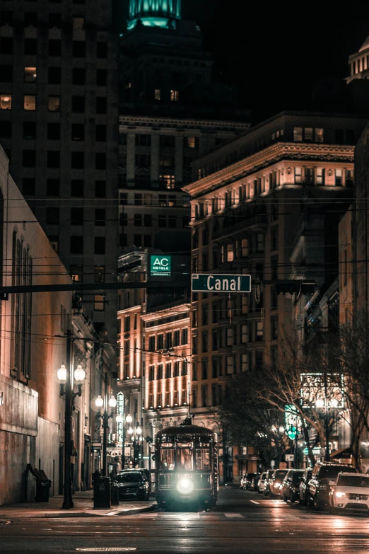 a trolley traveling down the street at night