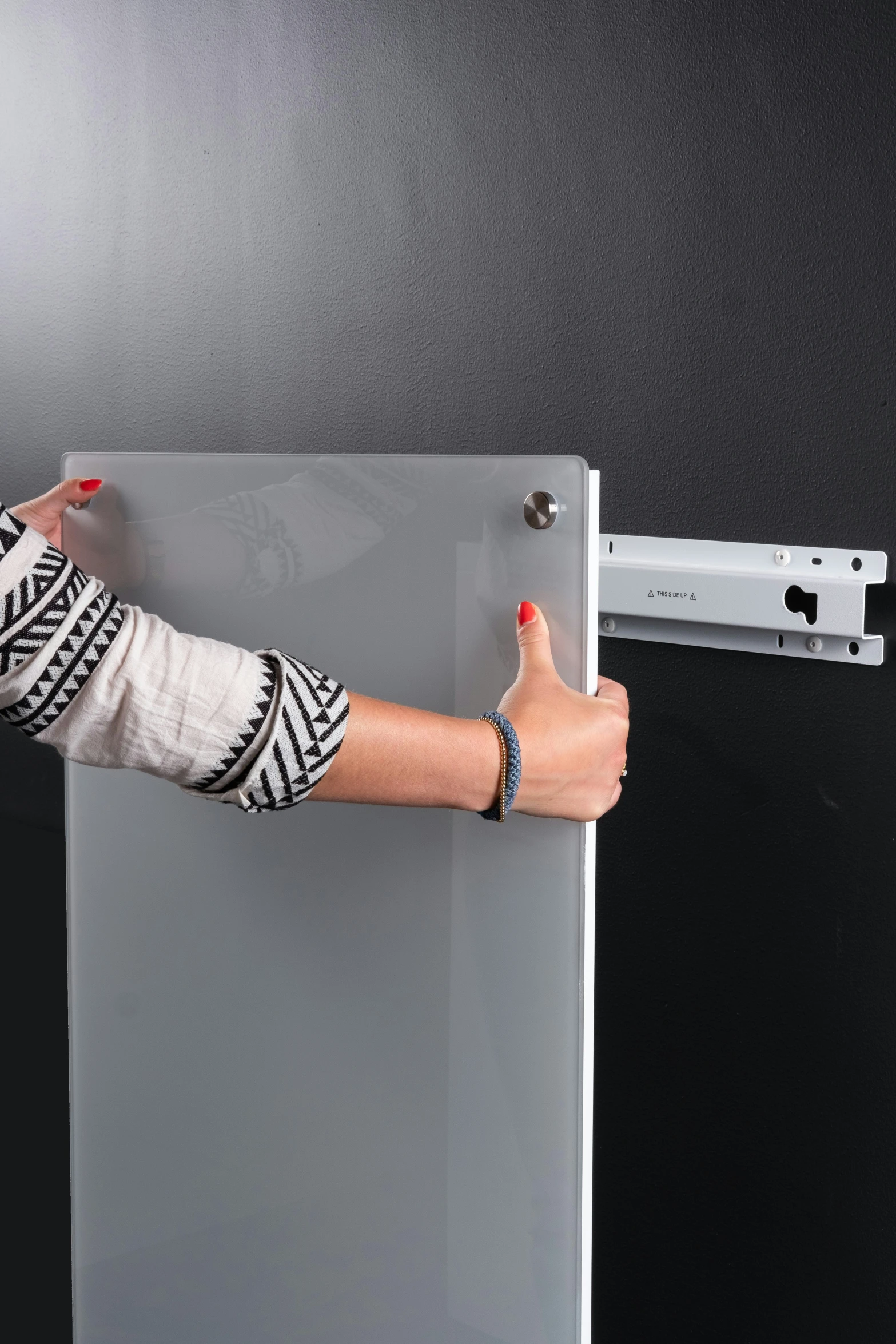 a woman opening and pointing at a door