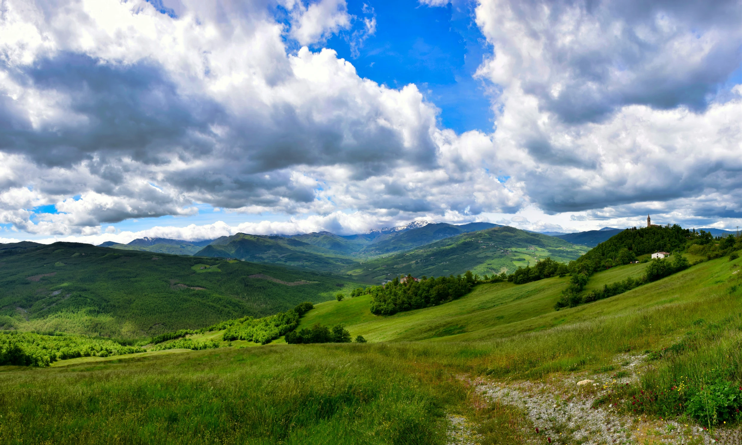 clouds gather over the rolling hills and valley