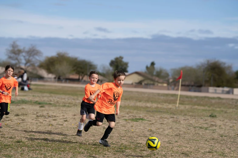 several s run after a soccer ball