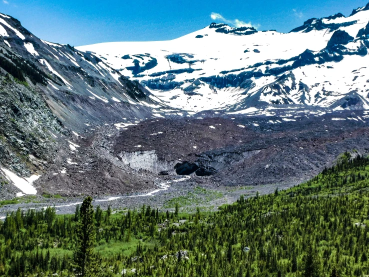 a valley in the mountains that is covered in snow