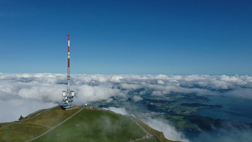 a cellphone tower above the clouds and water