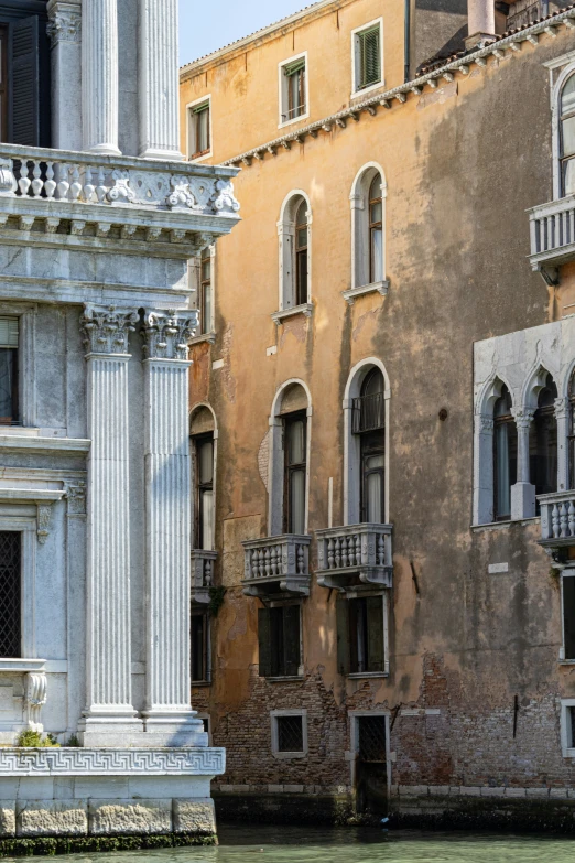 a row of stone pillars next to a tall building