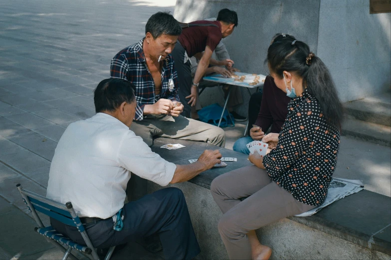 group of people sitting down to eat out on the steps