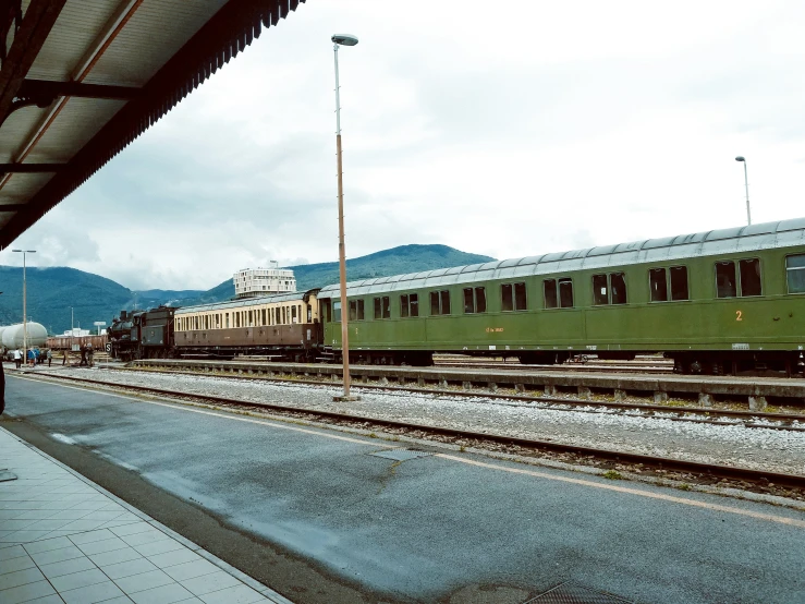 a passenger train on tracks in a rural town