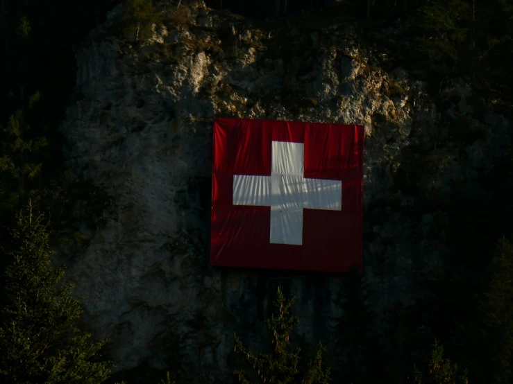 a cross is placed on the side of a cliff