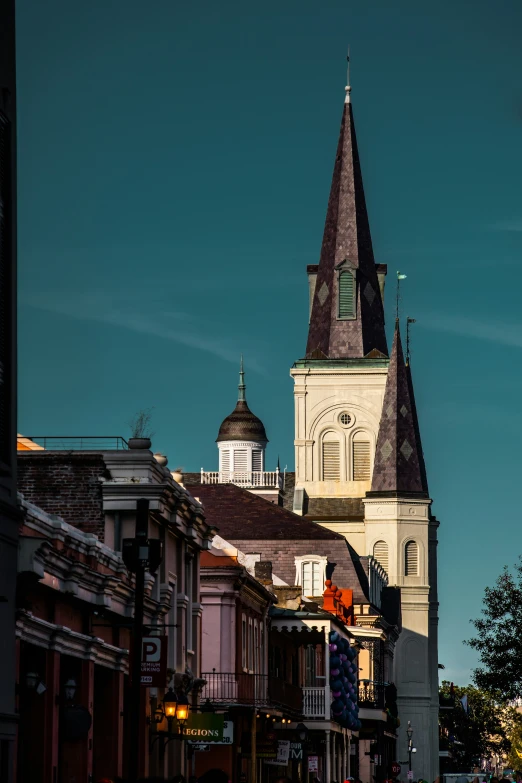 the steeple of an old church on a city street