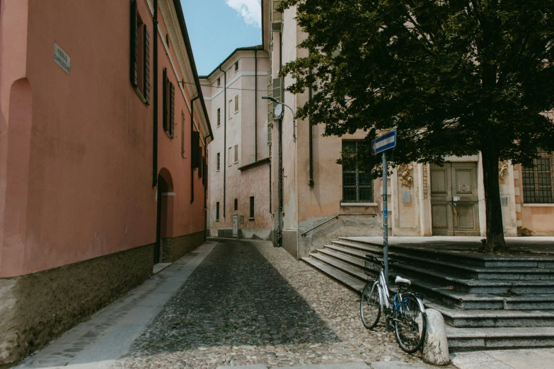 a bike leans against an old brick building