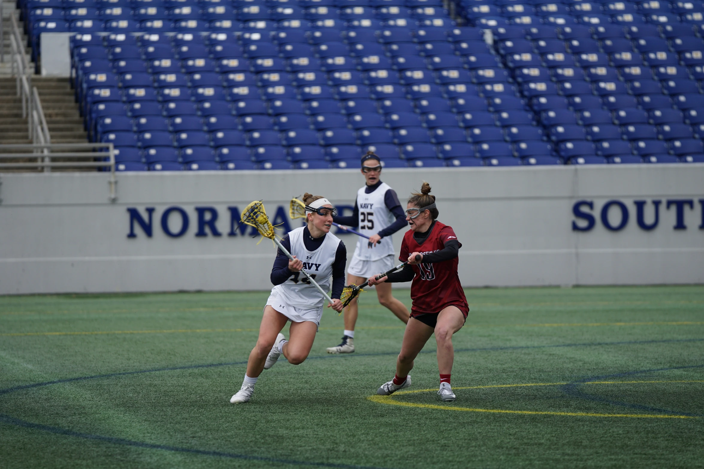 girls on field playing hockey against each other