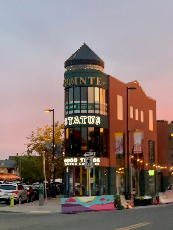 a building sits on a corner with people walking by