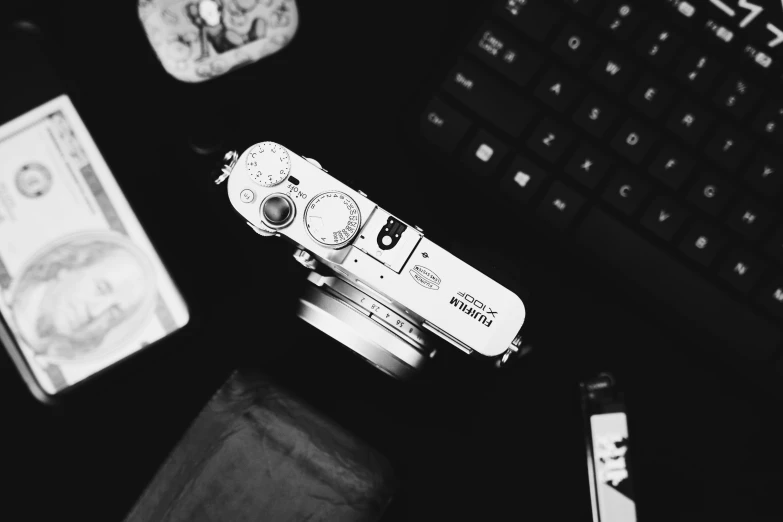 a close up of a camera near a computer keyboard