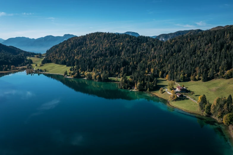 an aerial view of some large lake near the mountains