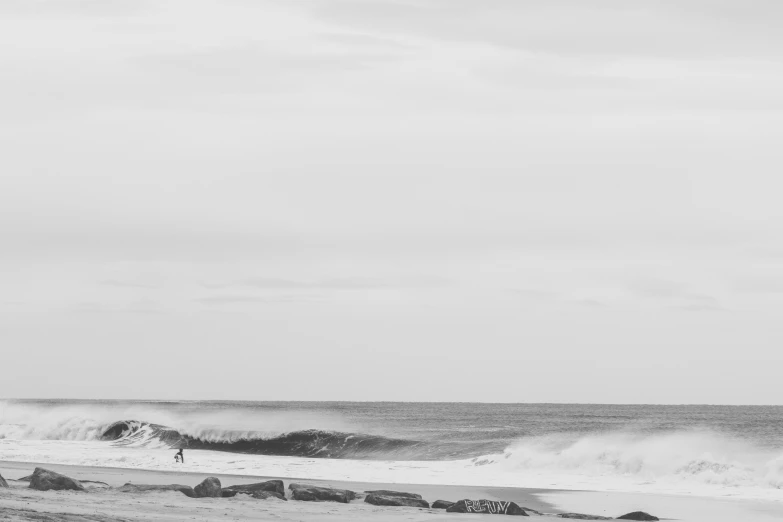 a black and white po of a beach with people near the water