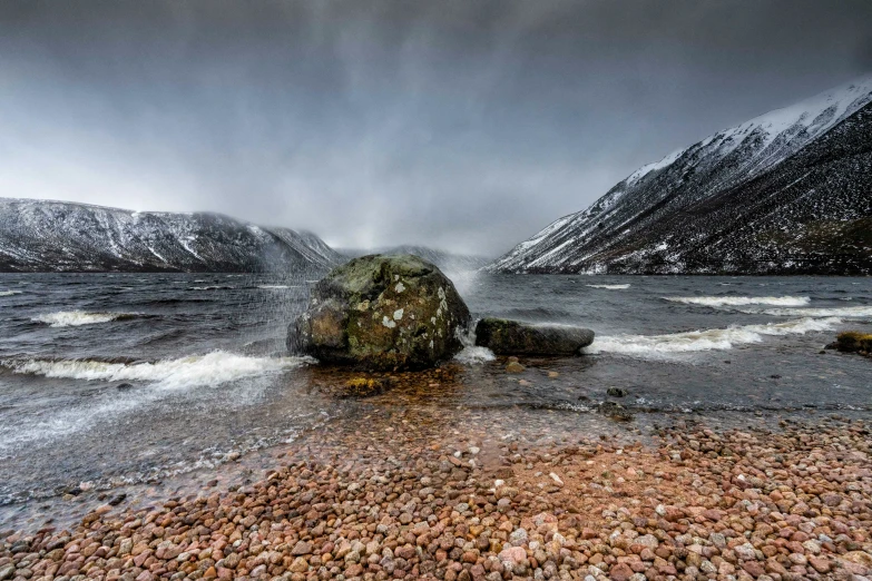 a large rock that is in the middle of some water