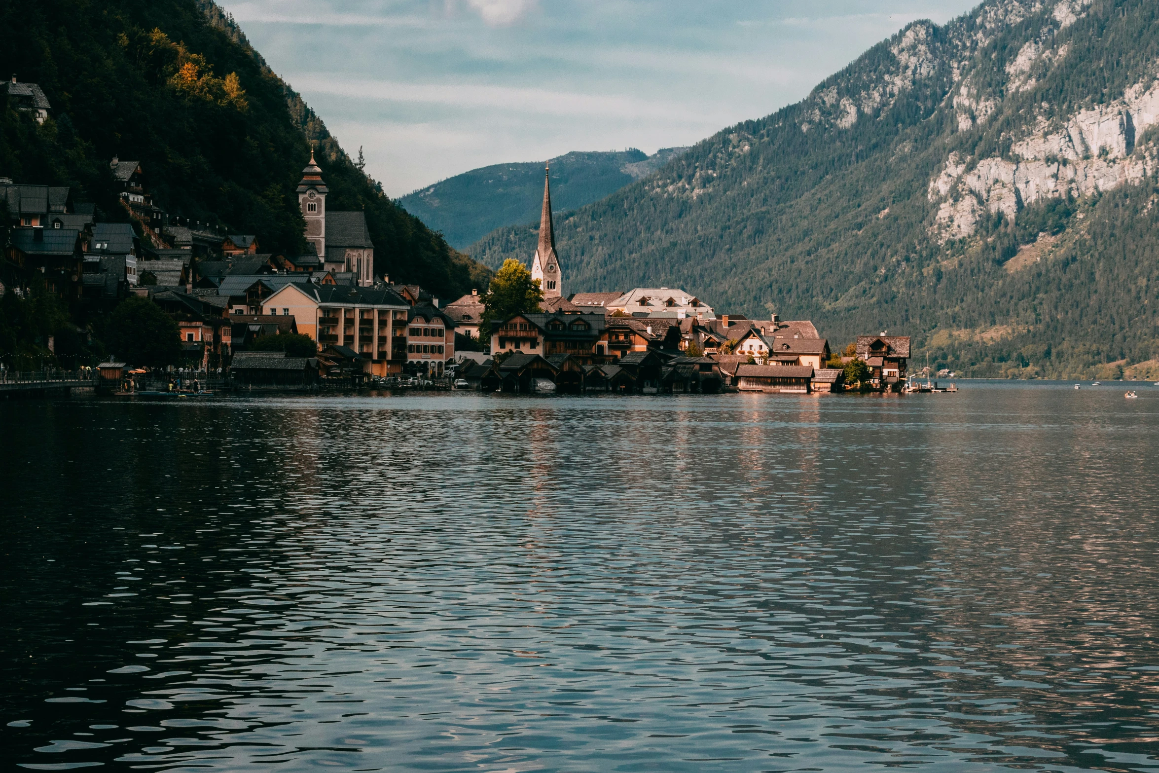 a town is perched on a mountain beside the water