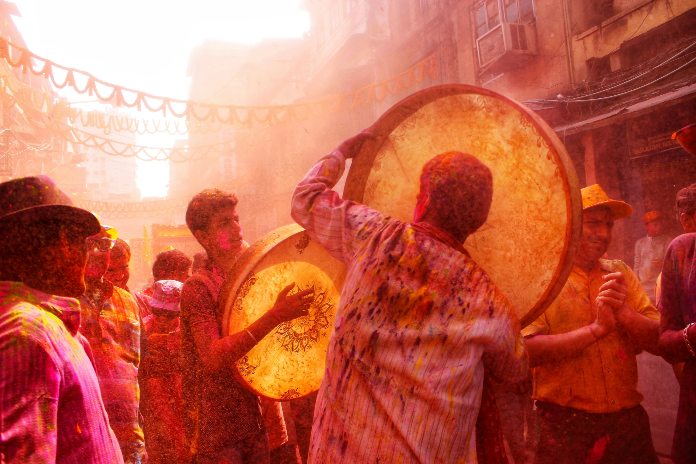 a group of people playing with colored powder and holi