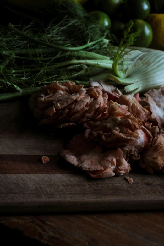 the meat is being chopped up on the wooden  board