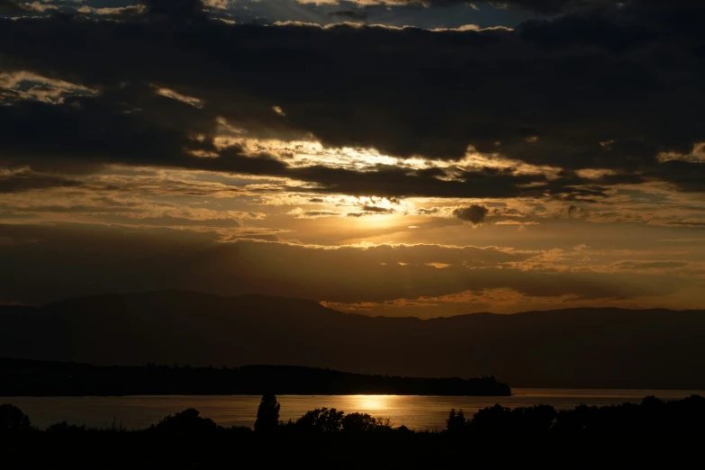 a large body of water under a cloudy sky