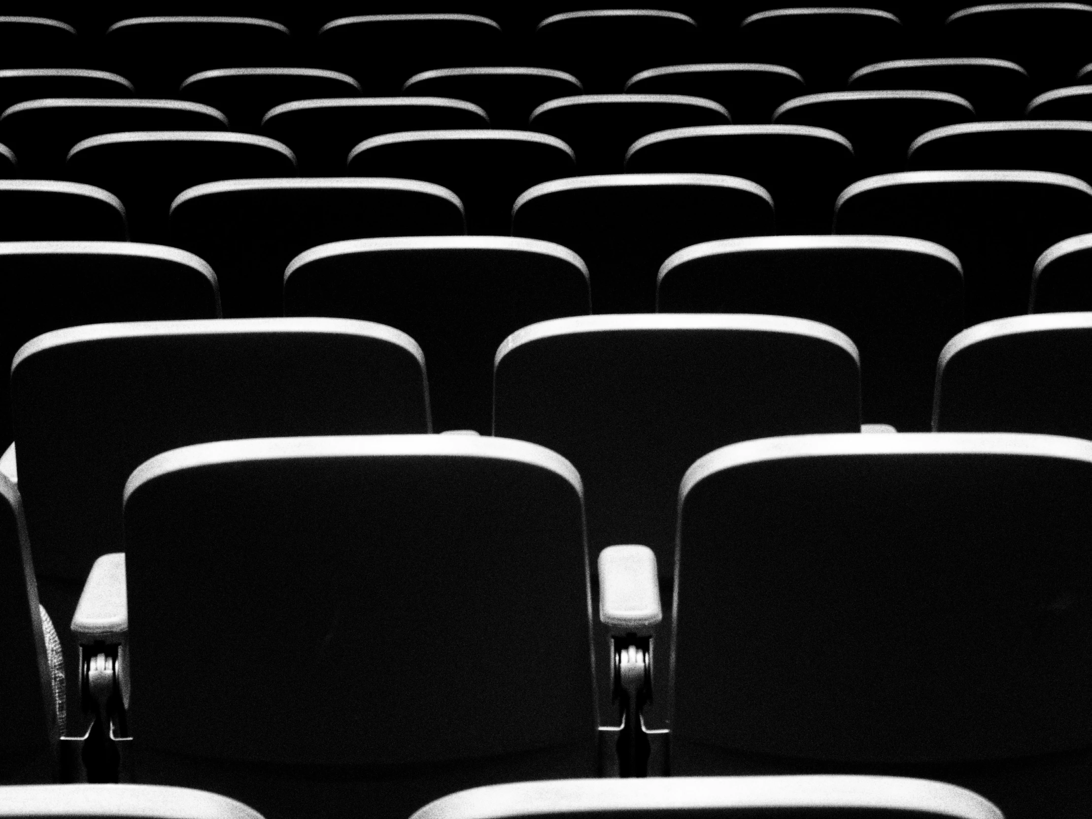 rows of empty chairs are facing one another