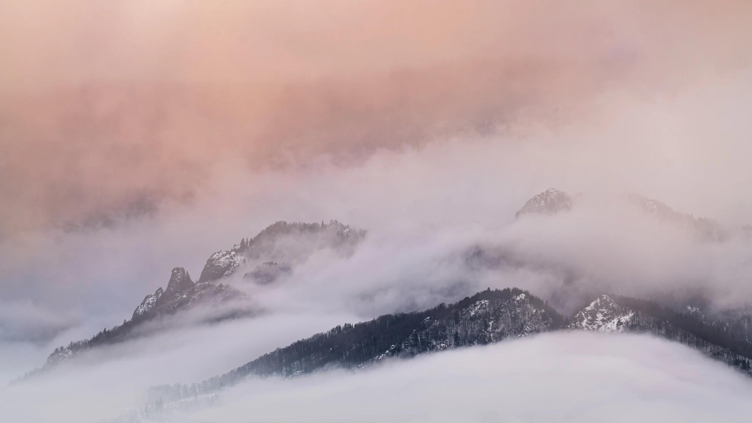 a couple of mountain with snow on the mountains