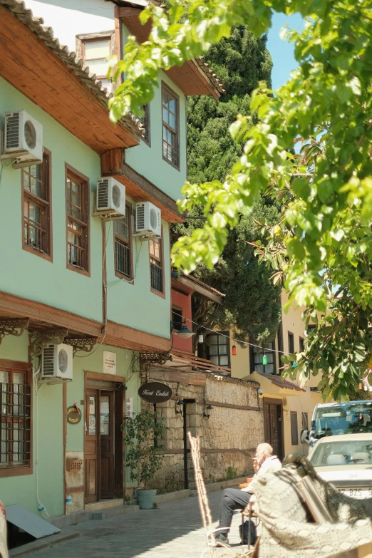 a man sits alone near the front of a multi - colored building