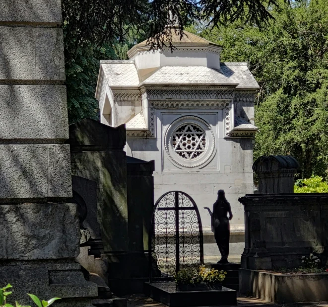 an entry gate to a monument near a cemetery
