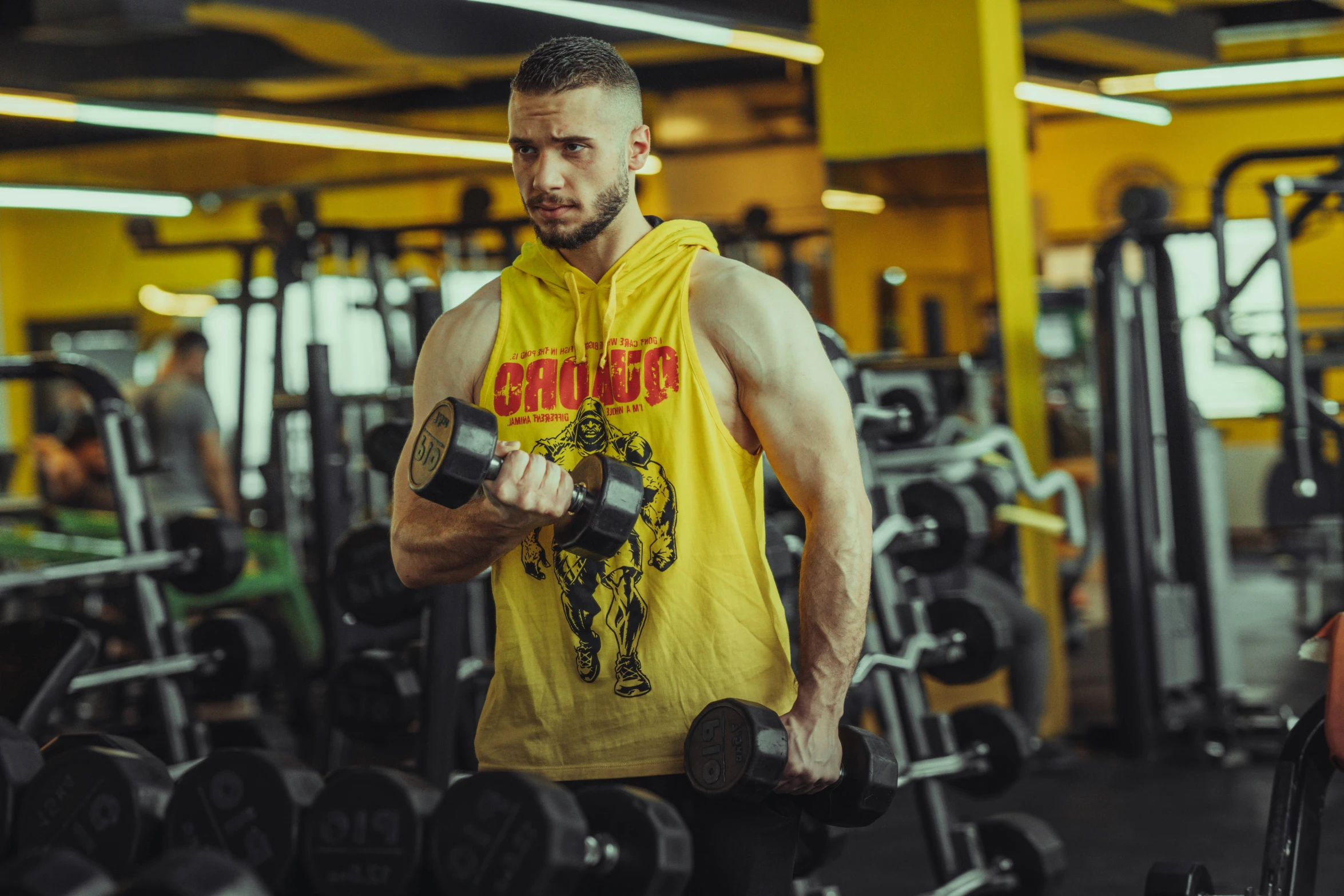 a man standing in front of many weights