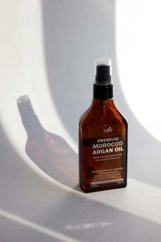 a bottle of moroccan oil sitting on top of a white table