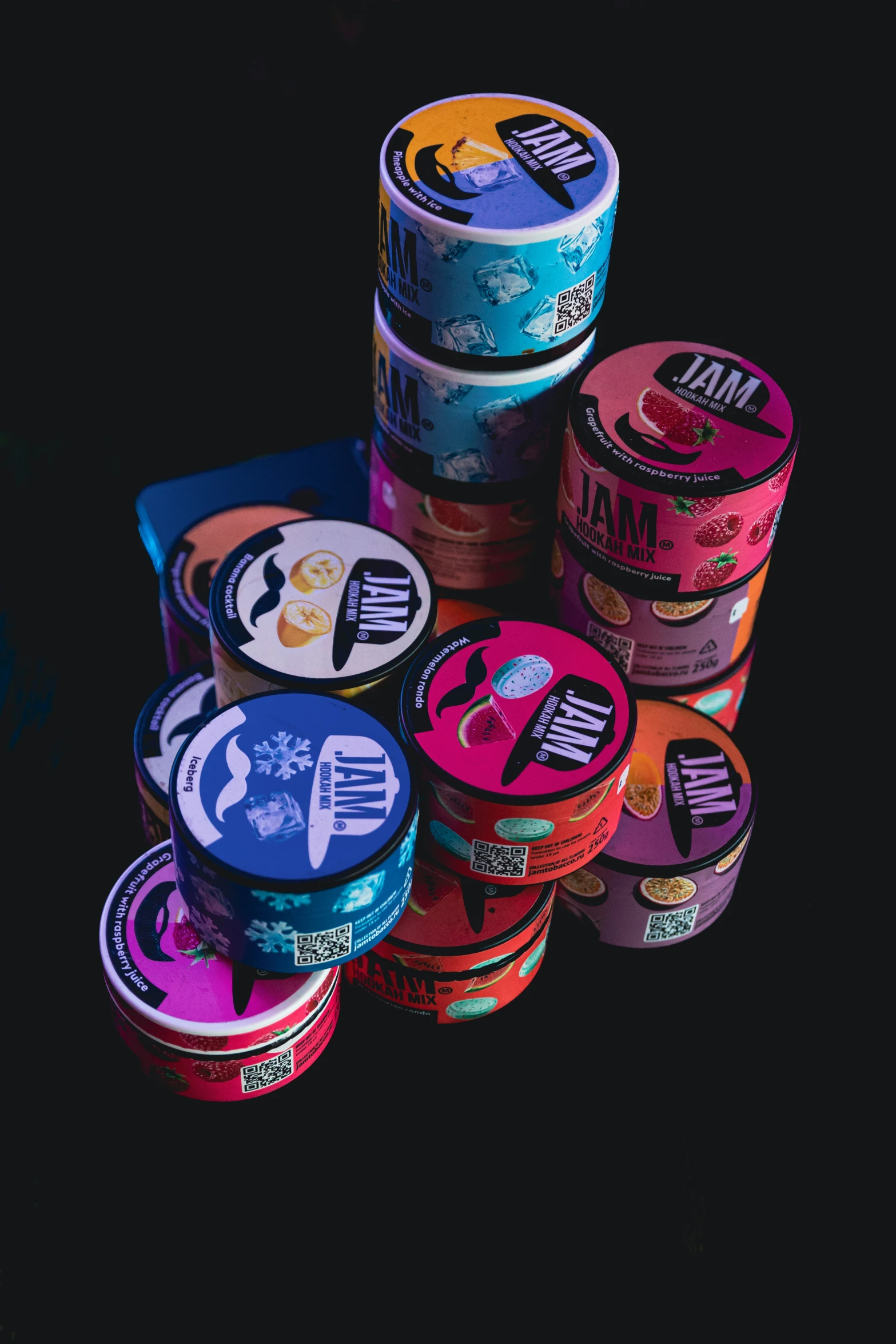 seven tubs of brightly colored ice cream sitting on a table