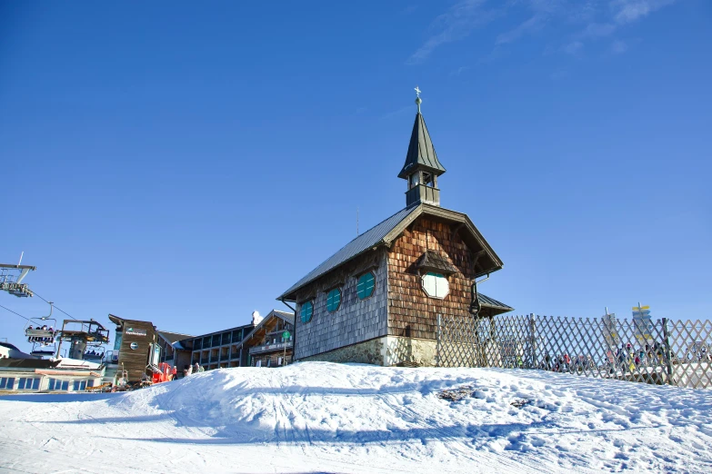 the building is made out of wooden and has a steeple