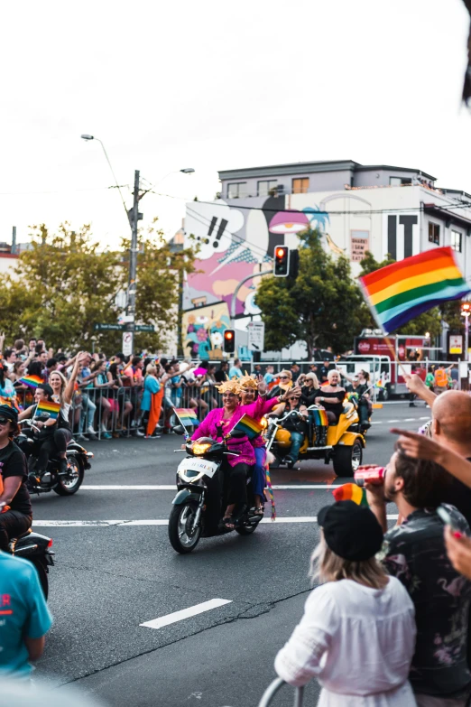an image of a street parade with bikers