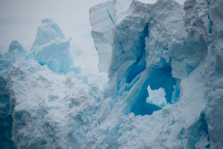 a large ice cliff on a foggy day