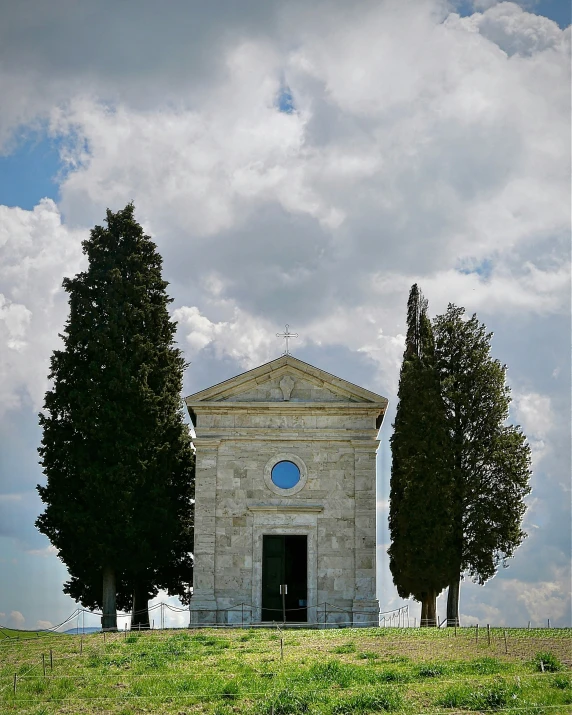 the chapel is surrounded by three large trees