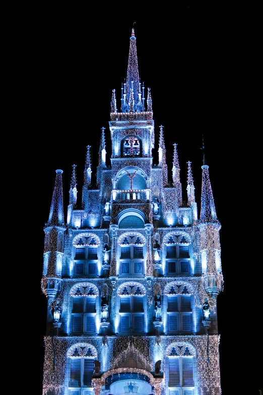 illuminated building at night with clocks and decorations