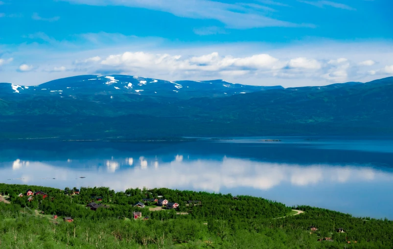 a very big beautiful blue body of water surrounded by mountains