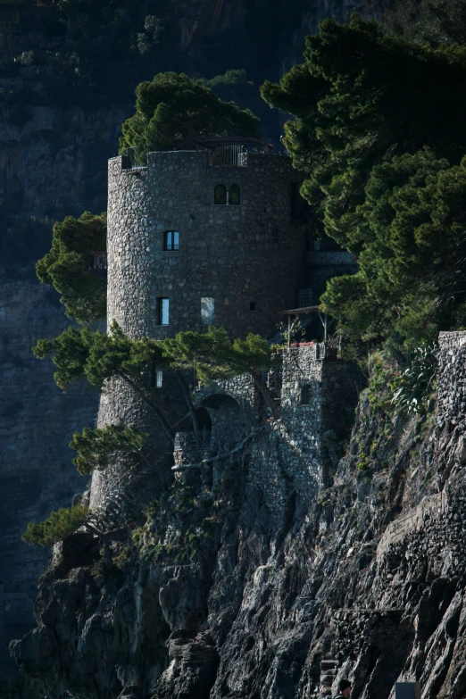 a rock mountain with a very tall building