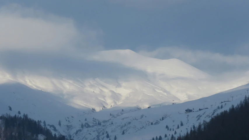 a mountain scene has snow on the mountains