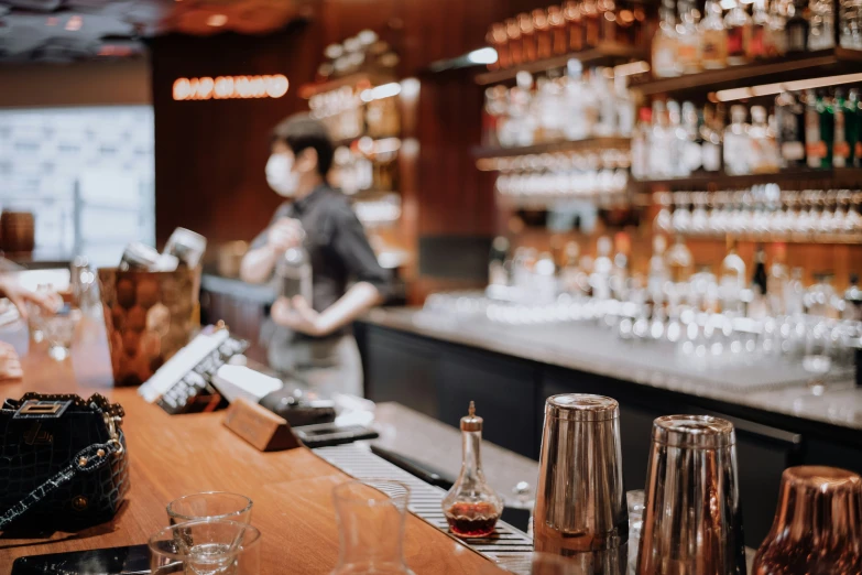 there are many wine glasses lined on the bar