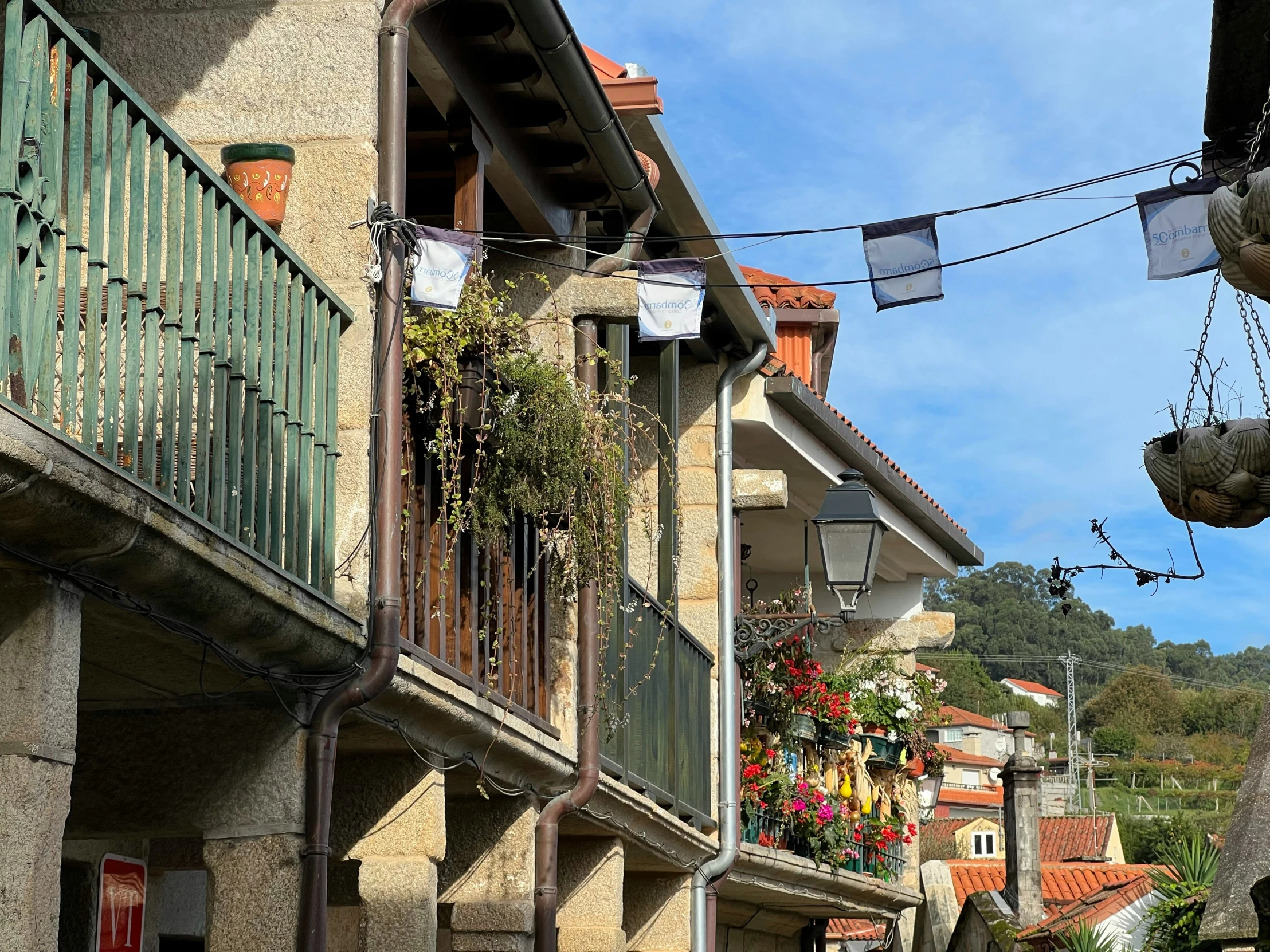 a street in a town is full of stone buildings and balconies