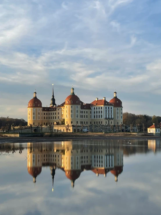 large building with domes is next to the water