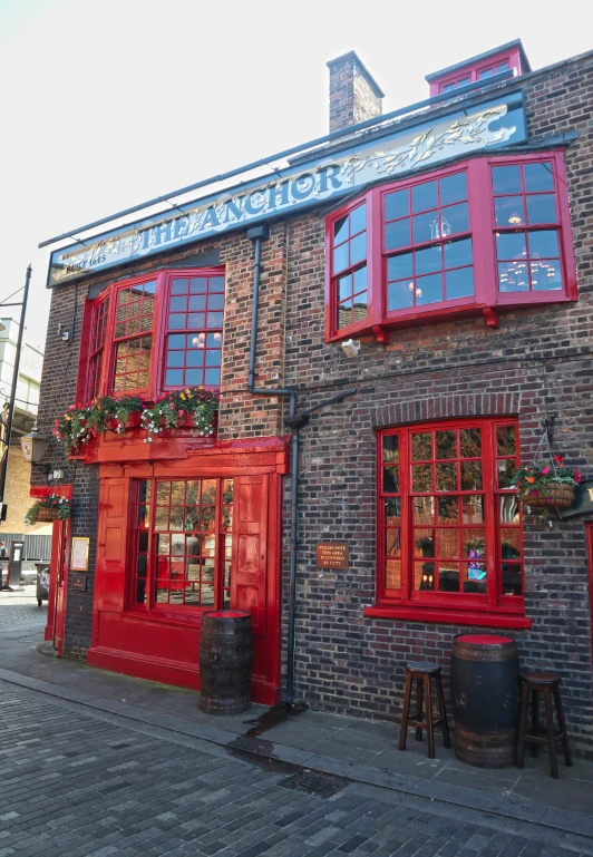 a brick building has red doors and windows