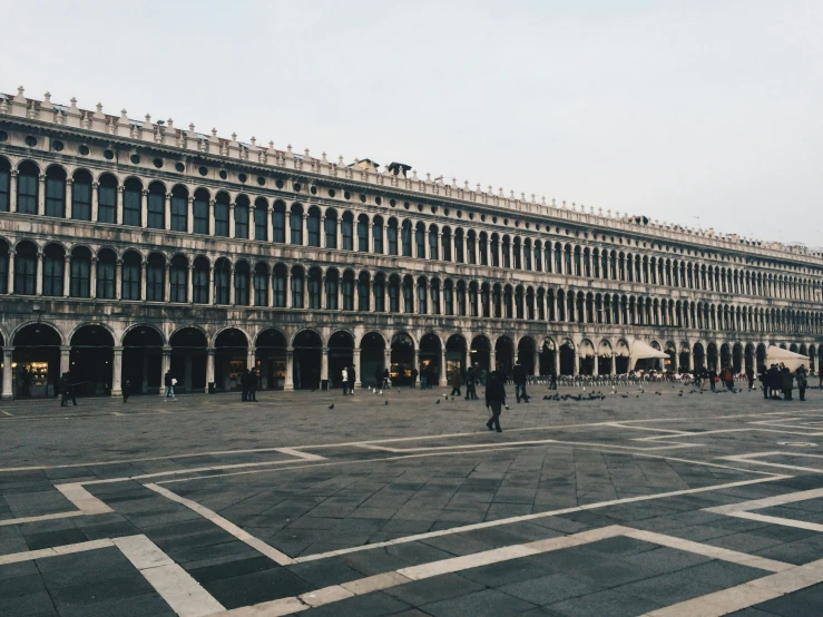 people and horses are in front of a building