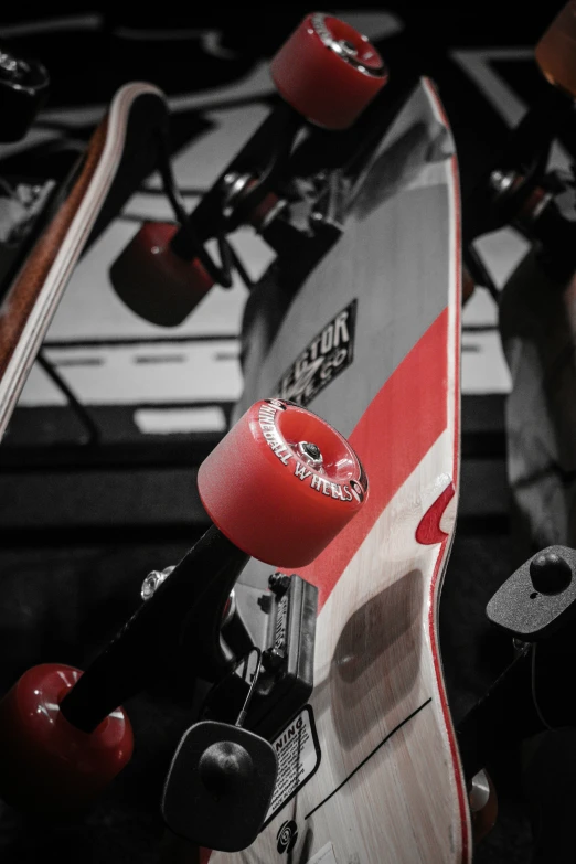 a closeup of a red and white skateboard on a rack