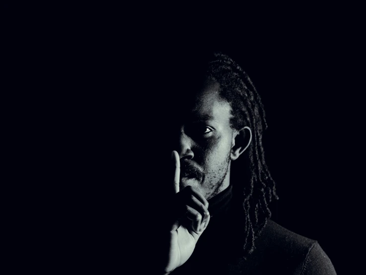 a man with dreadlocks is staring at the camera