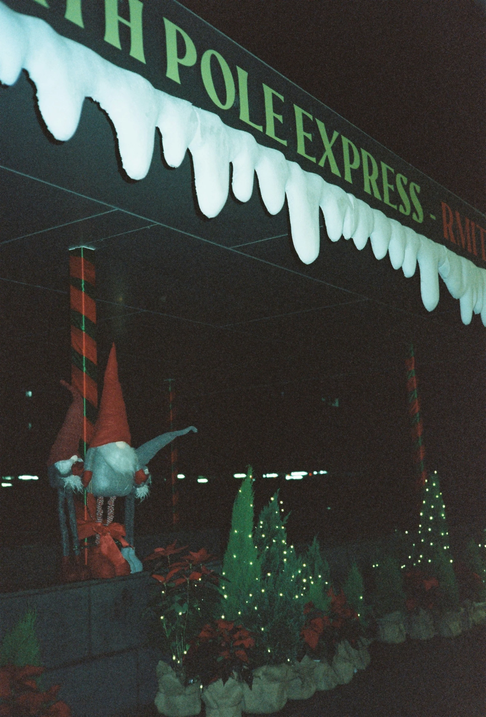 a merry yard with decorations, snow and a pole