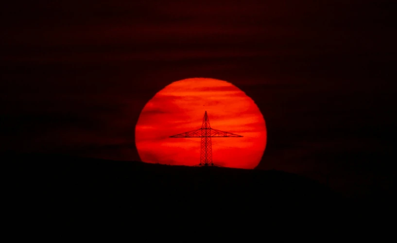 a large tower with a red sky in the background