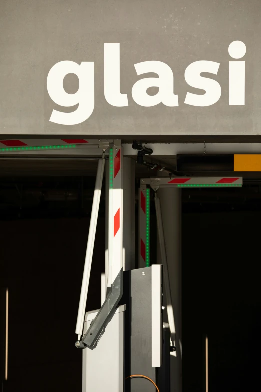 there is a white glasi sign on a post