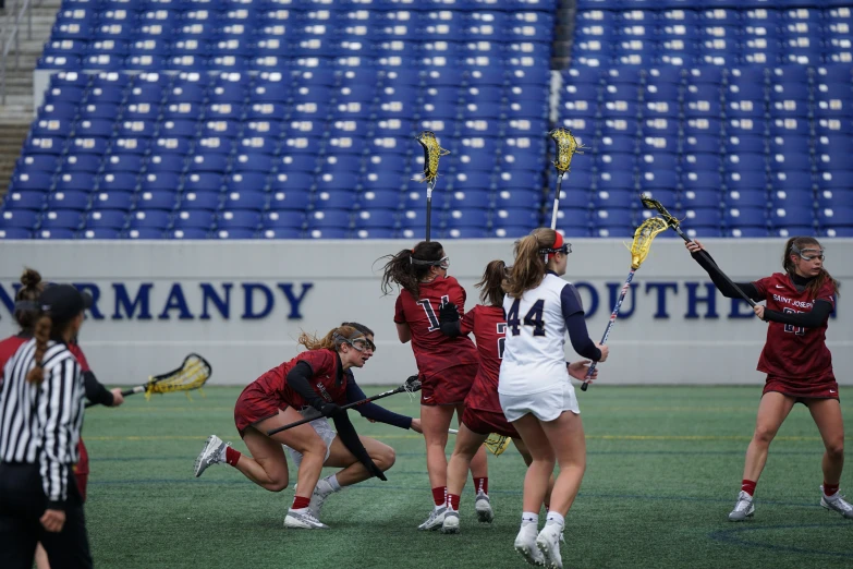 a group of women playing a game of lacrosse