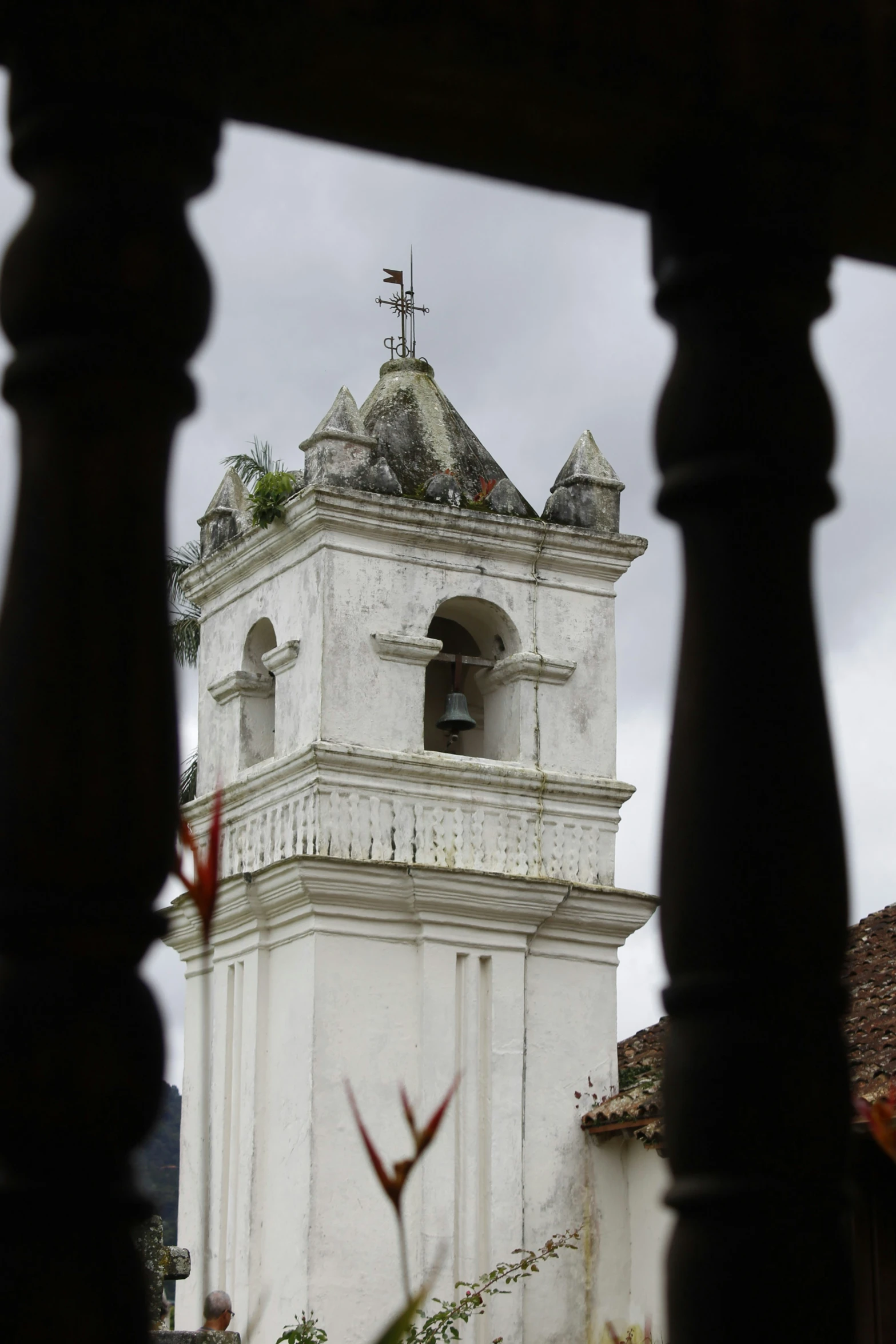 a white tower on top of a building with bells