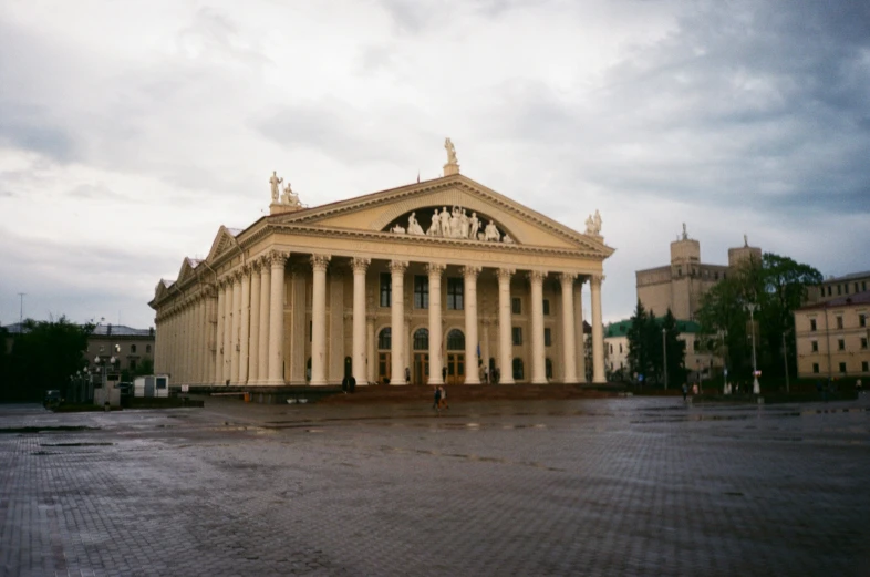 two story building with columns and a very large clock tower